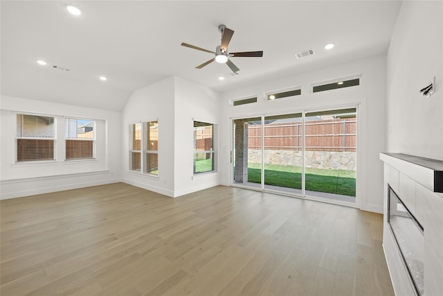 unfurnished living room with light hardwood / wood-style floors, ceiling fan, and lofted ceiling