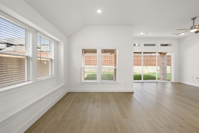 unfurnished room with hardwood / wood-style flooring, ceiling fan, and lofted ceiling