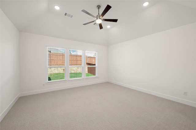 carpeted spare room with ceiling fan and lofted ceiling