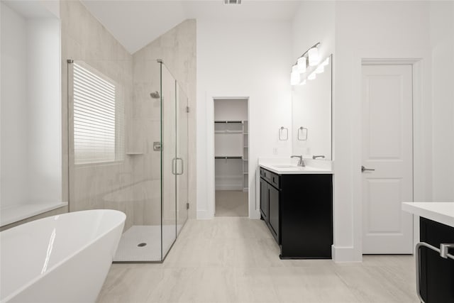 bathroom featuring vanity, lofted ceiling, and independent shower and bath