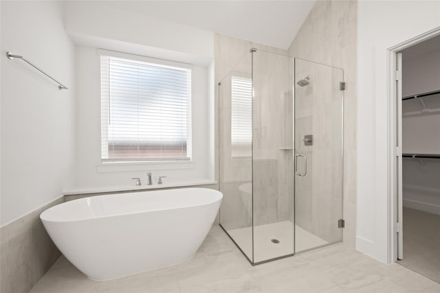 bathroom featuring separate shower and tub