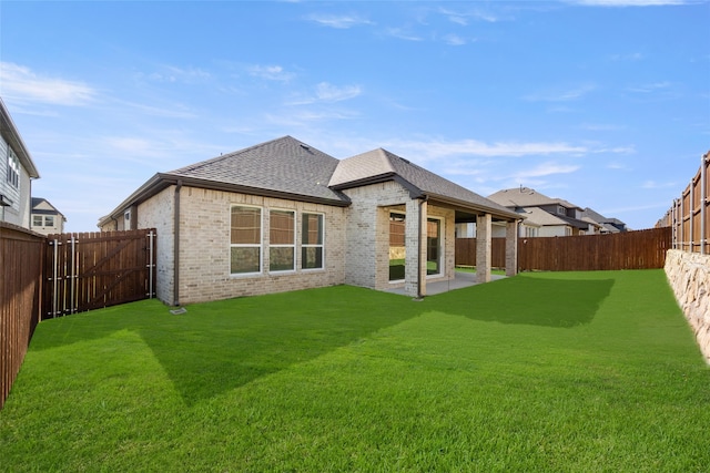 back of house with a lawn