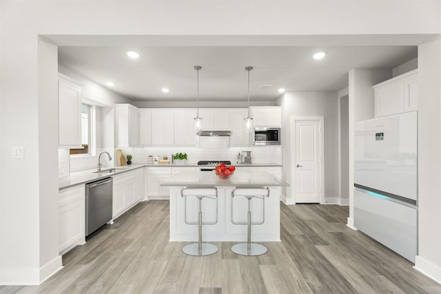 kitchen featuring a center island, white cabinetry, and appliances with stainless steel finishes