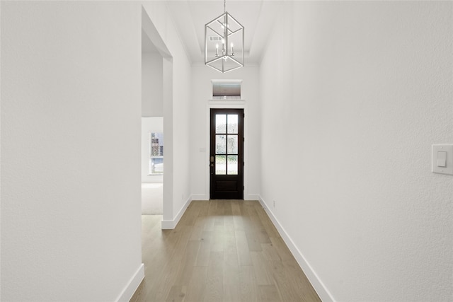 entryway featuring a chandelier and light hardwood / wood-style floors