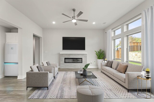 living room featuring light wood-type flooring and ceiling fan