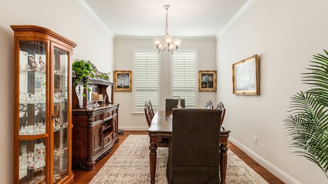 dining room featuring an inviting chandelier, ornamental molding, and dark hardwood / wood-style flooring