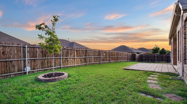 yard at dusk with a patio