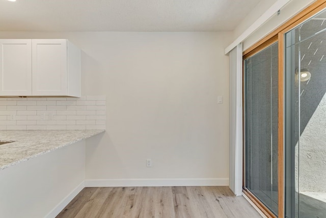 unfurnished dining area with light hardwood / wood-style floors