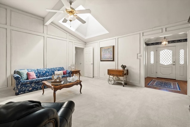 living room featuring ceiling fan, vaulted ceiling with beams, and light carpet