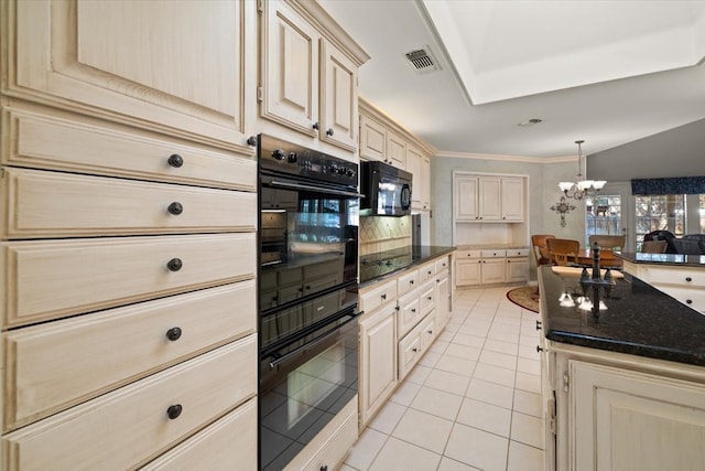 kitchen with hanging light fixtures, light tile patterned floors, black appliances, dark stone counters, and a chandelier