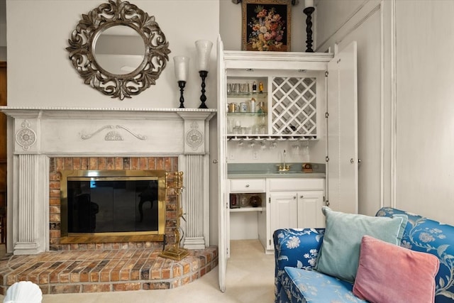 interior space with indoor wet bar and a fireplace