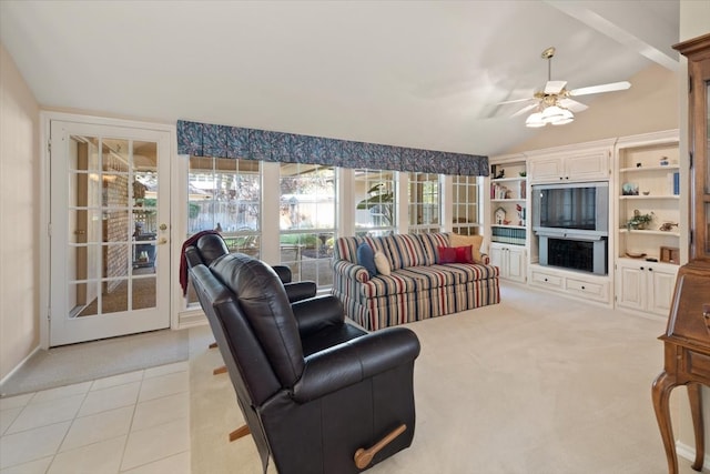 carpeted living room featuring vaulted ceiling and ceiling fan