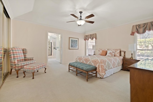 bedroom with ornamental molding, light carpet, ceiling fan, and ensuite bathroom