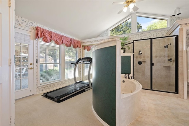 workout room with ceiling fan, lofted ceiling, and tile patterned floors