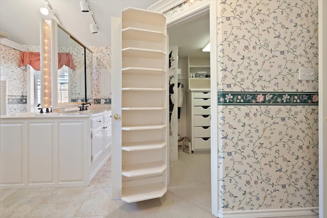 bathroom with tile patterned flooring, track lighting, and vanity