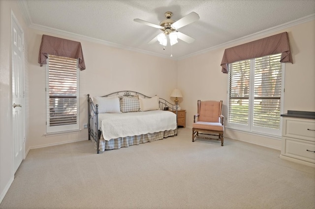 carpeted bedroom with ornamental molding, ceiling fan, and a textured ceiling