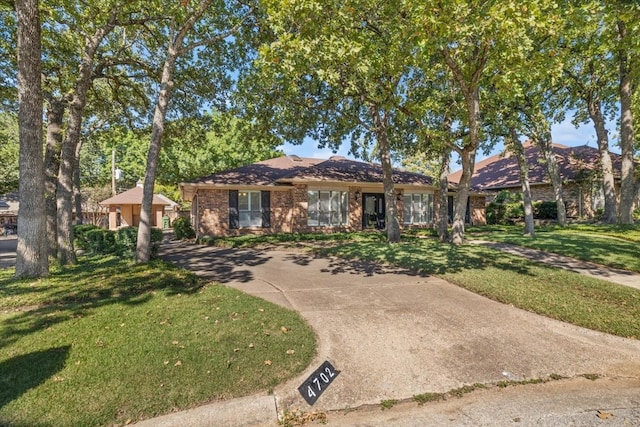 ranch-style home with a front lawn