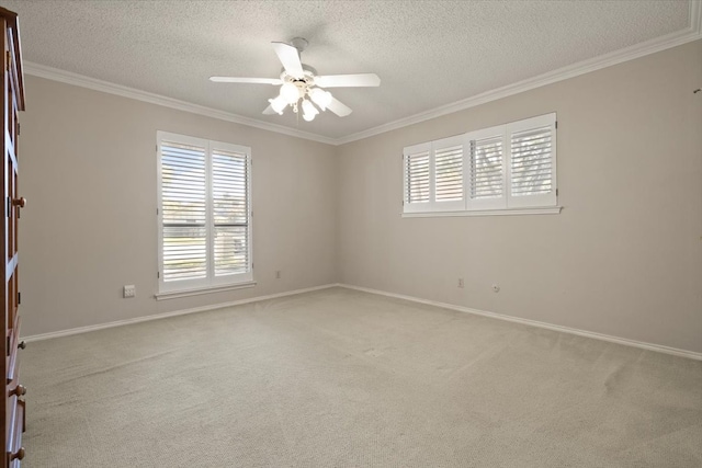 carpeted spare room featuring a textured ceiling, ceiling fan, and crown molding