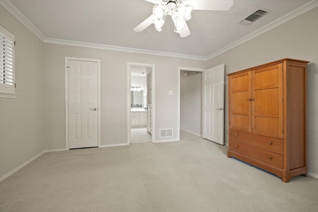 unfurnished bedroom with ceiling fan, light colored carpet, and a textured ceiling