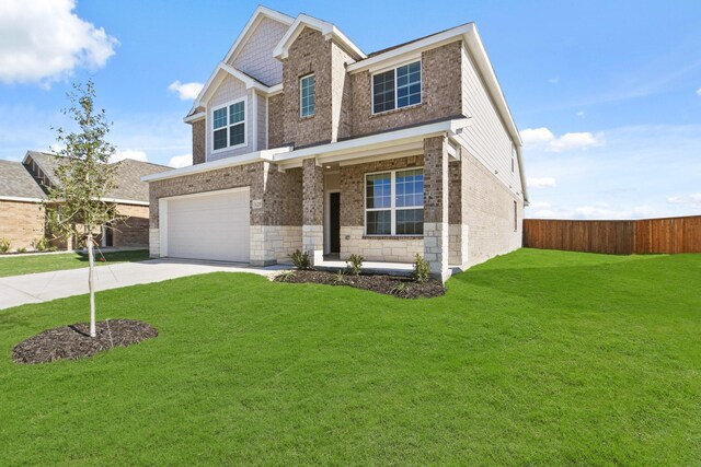 view of front of property featuring a garage and a front lawn