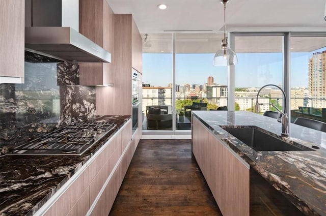 3130 N Harwood St Unit 1506, Dallas, TX 75201 - kitchen with a city view, modern cabinets, appliances with stainless steel finishes, a sink, and wall chimney range hood