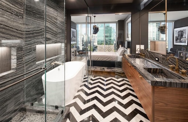 bathroom featuring independent shower and bath, vanity, and tile walls