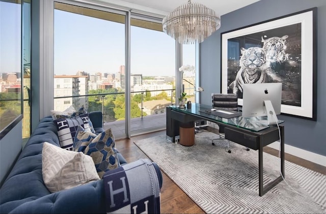 office with hardwood / wood-style flooring and a notable chandelier