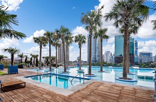 view of swimming pool with a hot tub and a patio