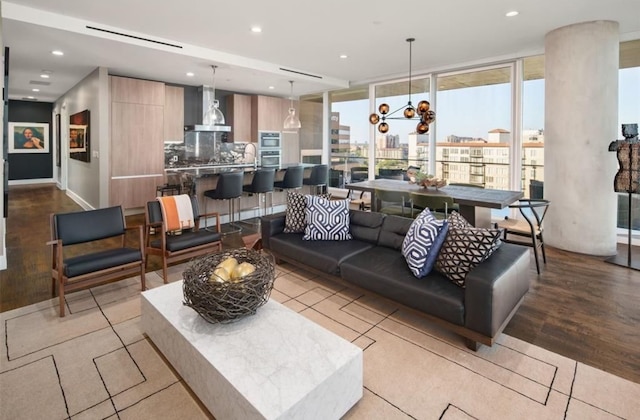 living room featuring a wall of windows and light hardwood / wood-style floors