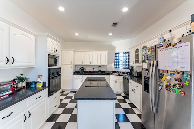 kitchen featuring white cabinets, a center island, sink, and black appliances