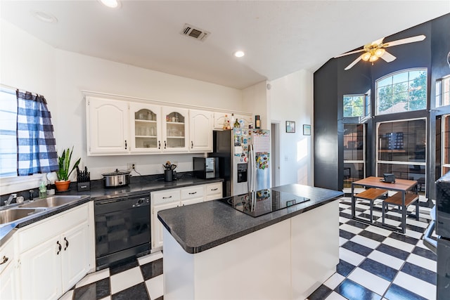 kitchen featuring white cabinets, a kitchen island, black appliances, ceiling fan, and sink