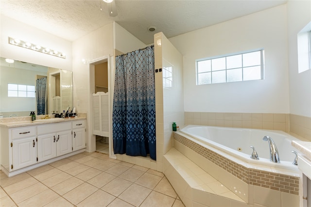 bathroom featuring vanity, shower with separate bathtub, a textured ceiling, and tile patterned floors