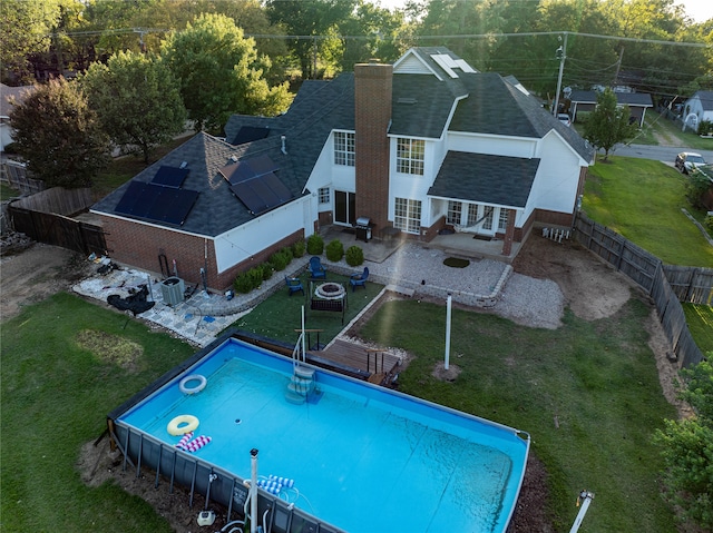 view of pool featuring a lawn and a patio area