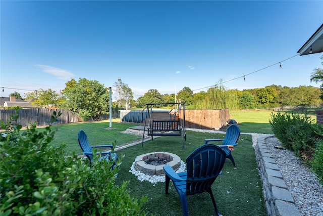 view of yard with an outdoor fire pit