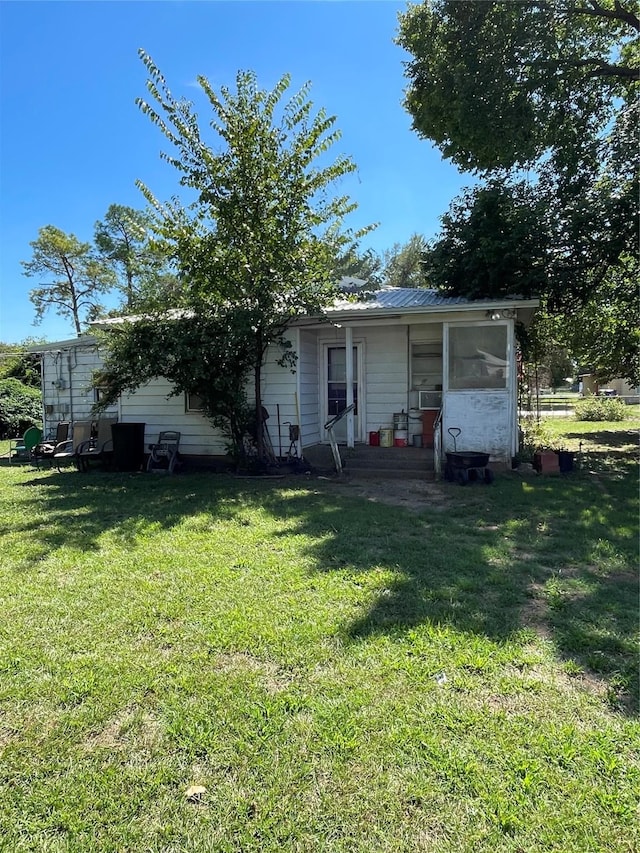 view of front of home with a front yard and cooling unit