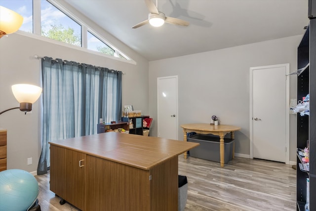 home office with ceiling fan, lofted ceiling, and light wood-type flooring