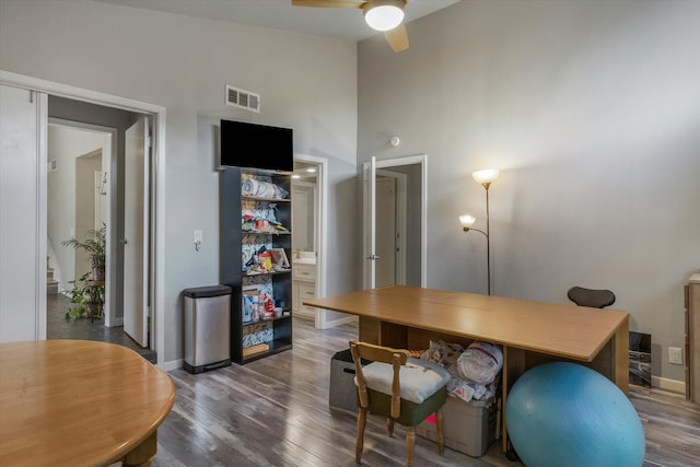 office area featuring dark hardwood / wood-style floors, ceiling fan, and high vaulted ceiling