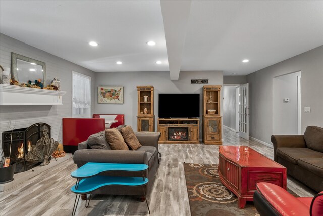 living room with light hardwood / wood-style flooring and a fireplace