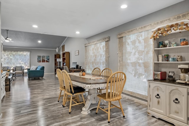 dining area featuring wood-type flooring, vaulted ceiling, and ceiling fan