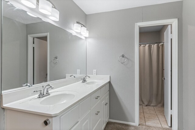 bathroom with tile patterned floors, a shower with curtain, and vanity