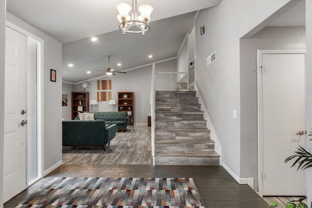 entrance foyer with ceiling fan with notable chandelier, crown molding, vaulted ceiling, and dark hardwood / wood-style flooring