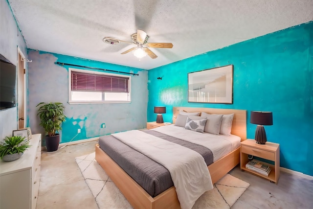 bedroom with ceiling fan and a textured ceiling