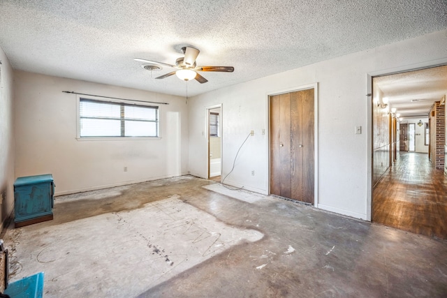 unfurnished bedroom featuring multiple closets, ceiling fan, hardwood / wood-style floors, and a textured ceiling