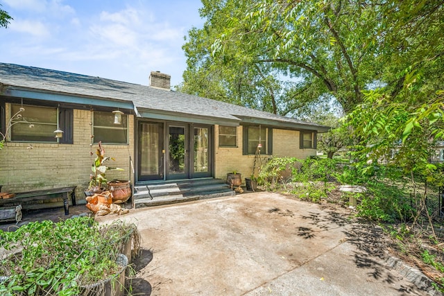 property entrance with french doors and a patio