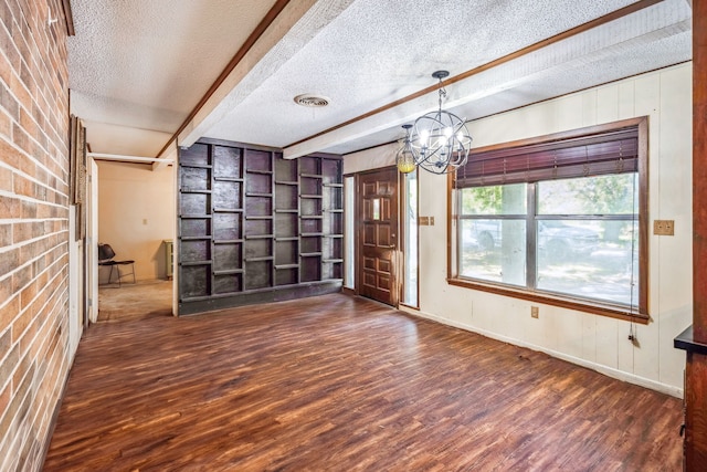 interior space with beamed ceiling, dark wood-type flooring, a textured ceiling, and a notable chandelier