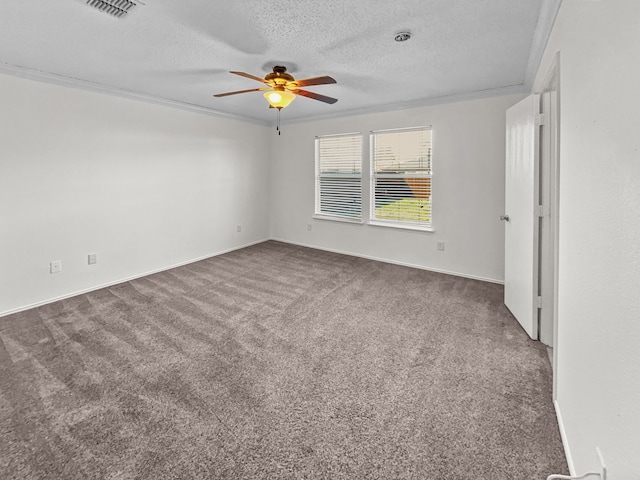 empty room featuring ceiling fan, dark carpet, crown molding, and a textured ceiling