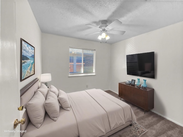 bedroom with carpet, ceiling fan, and a textured ceiling