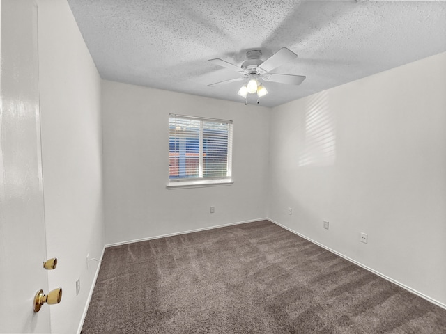 carpeted spare room with ceiling fan and a textured ceiling