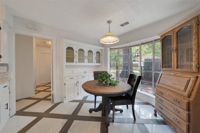 dining area with a textured ceiling