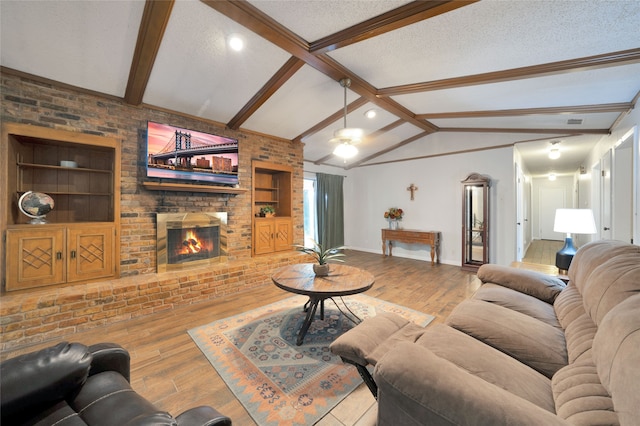 living room featuring built in features, a textured ceiling, and light hardwood / wood-style floors